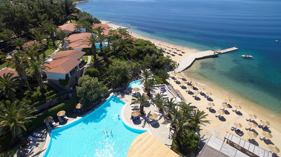 Aerial view of Eagles Resort with pool, beachfront and pier overlooking the sea