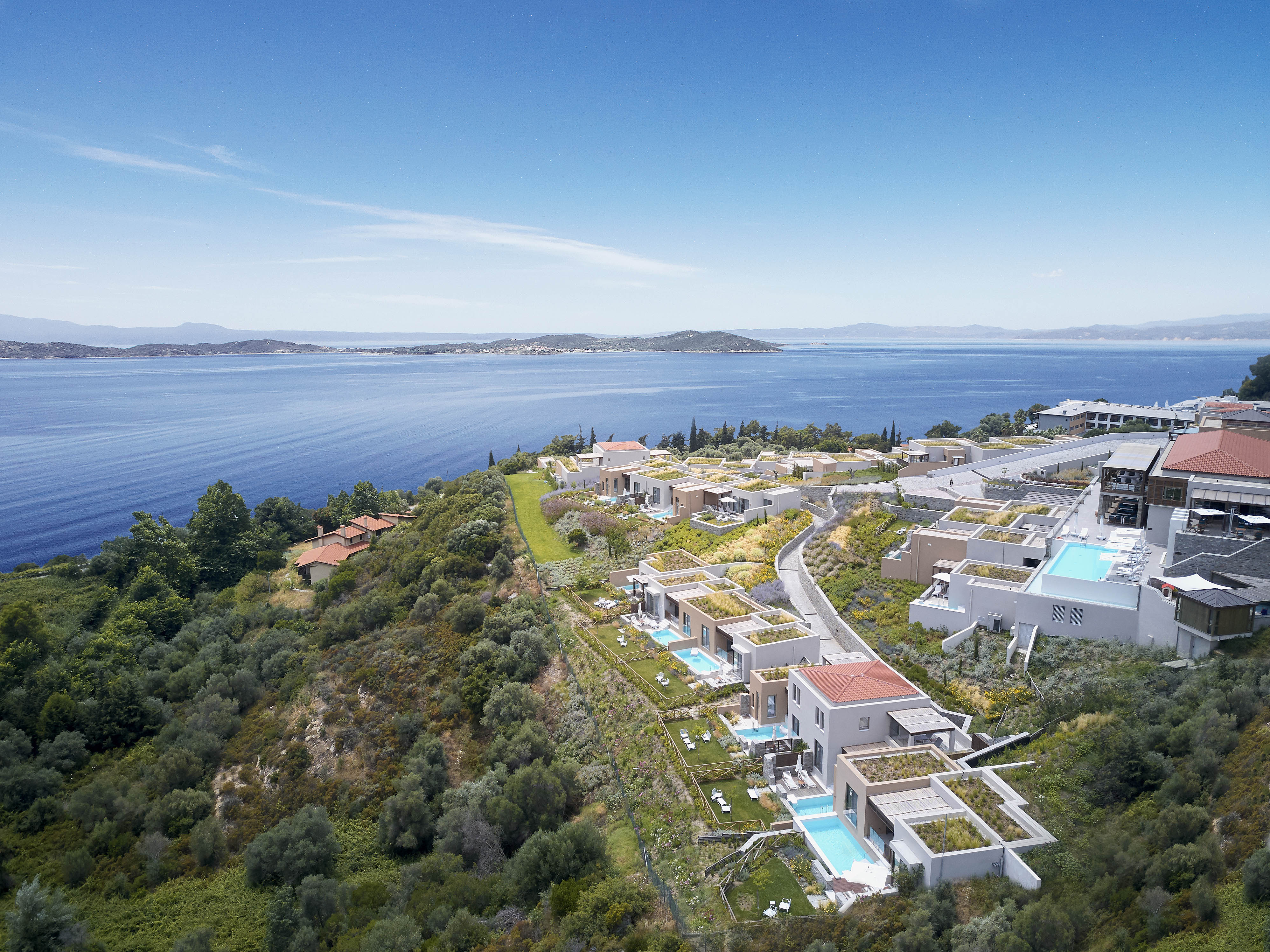 
Aerial view of luxury hillside villas with private pools overlooking the sea at Eagles Villas