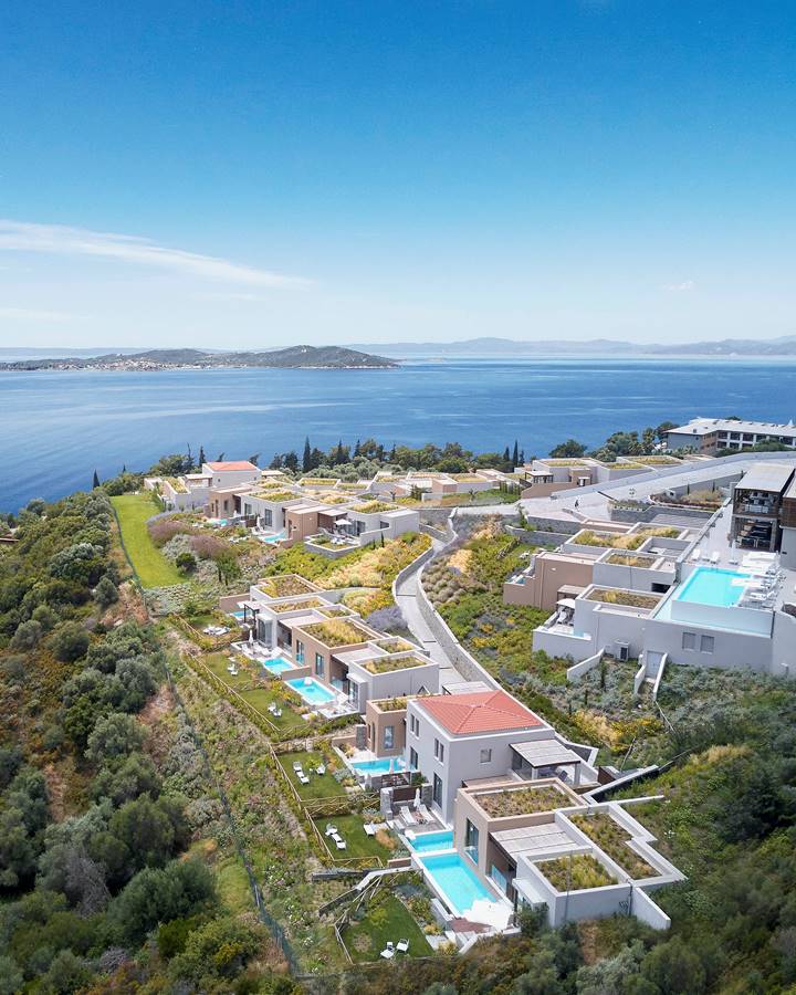 Aerial view of luxury hillside villas with private pools overlooking the sea at Eagles Villas